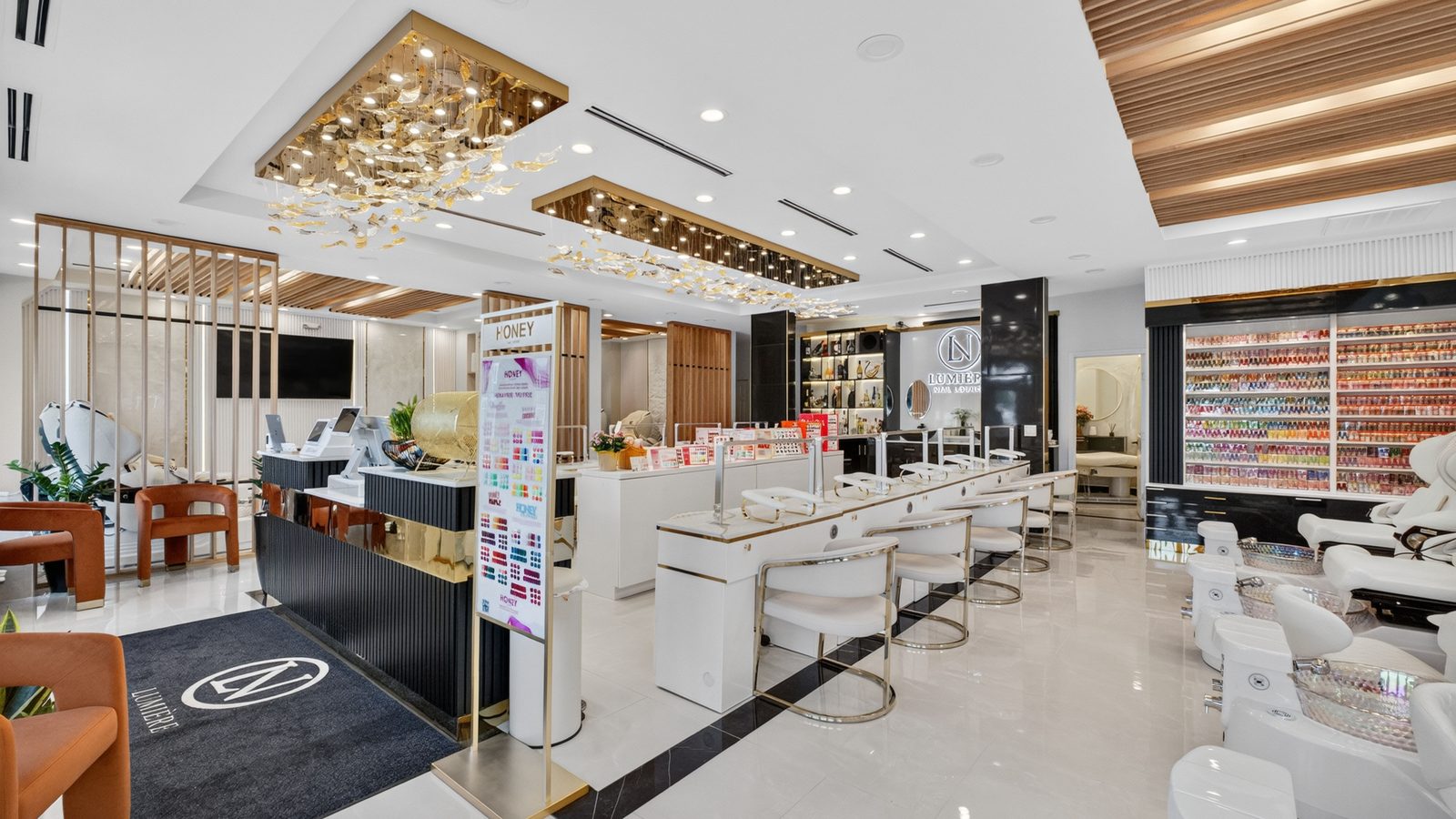The main floor of Lumière Nail Lounge beneath its gold crystal chandelier