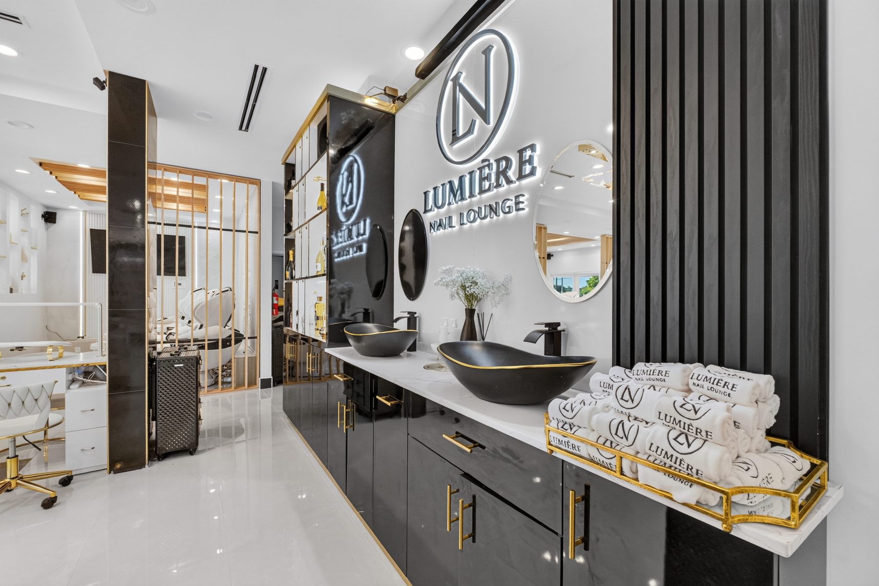 The Lumière monogram wall above the rinse station